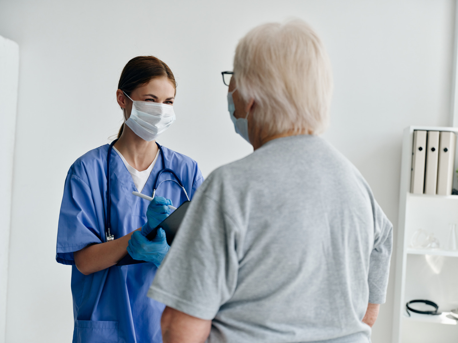 A nurse in consultation with a patient. 