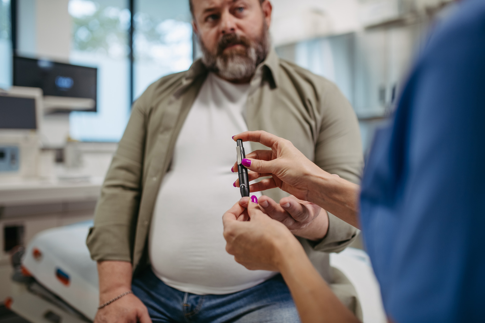 Man Holding A Glucose Monitoring Pen