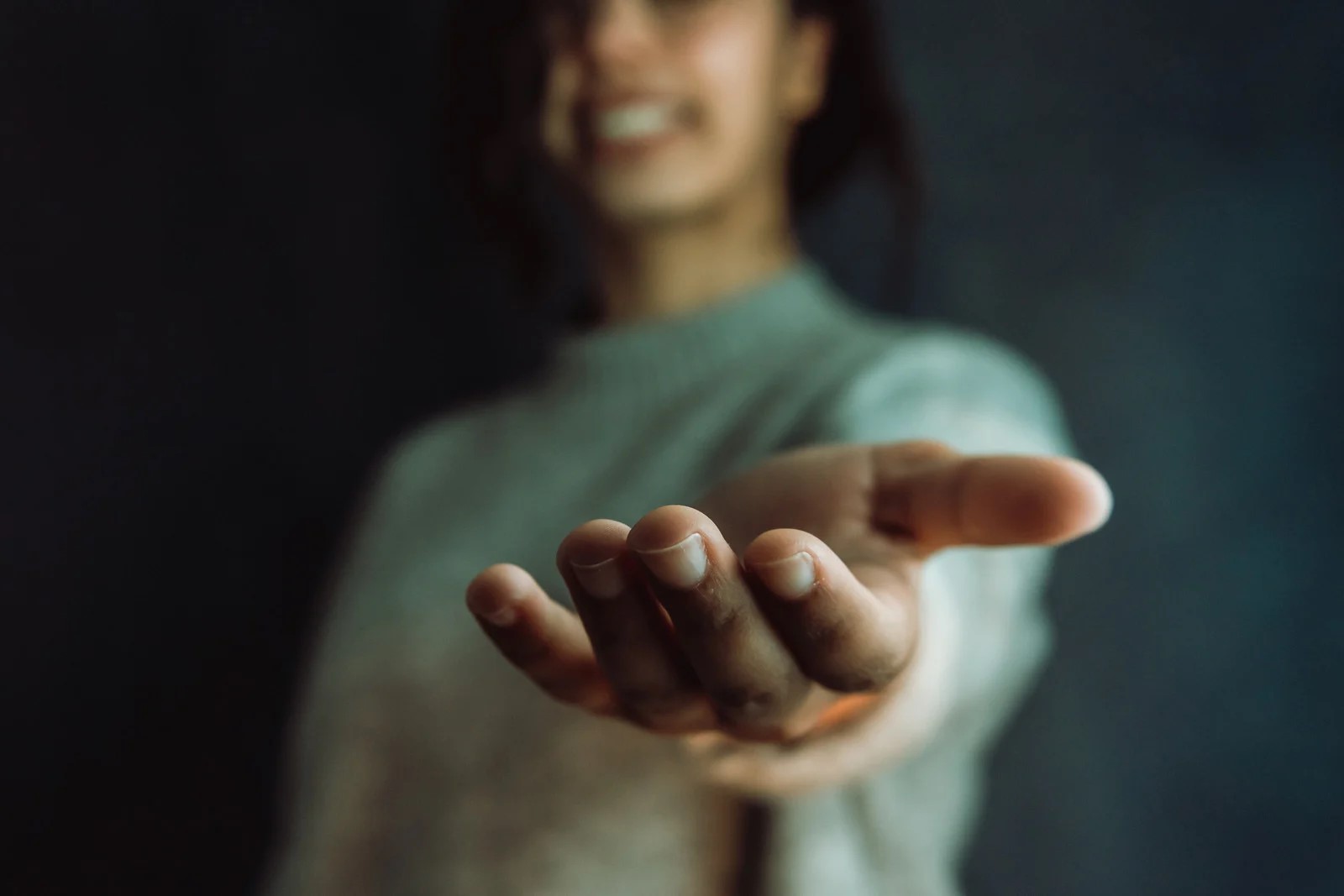 Woman Offering Hand To Camera
